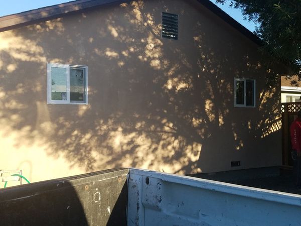Completed room addition exterior with stucco finish