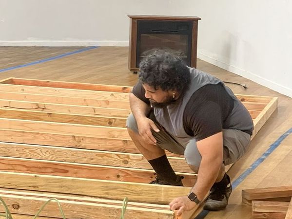 Carpenter working on precision subfloor installation