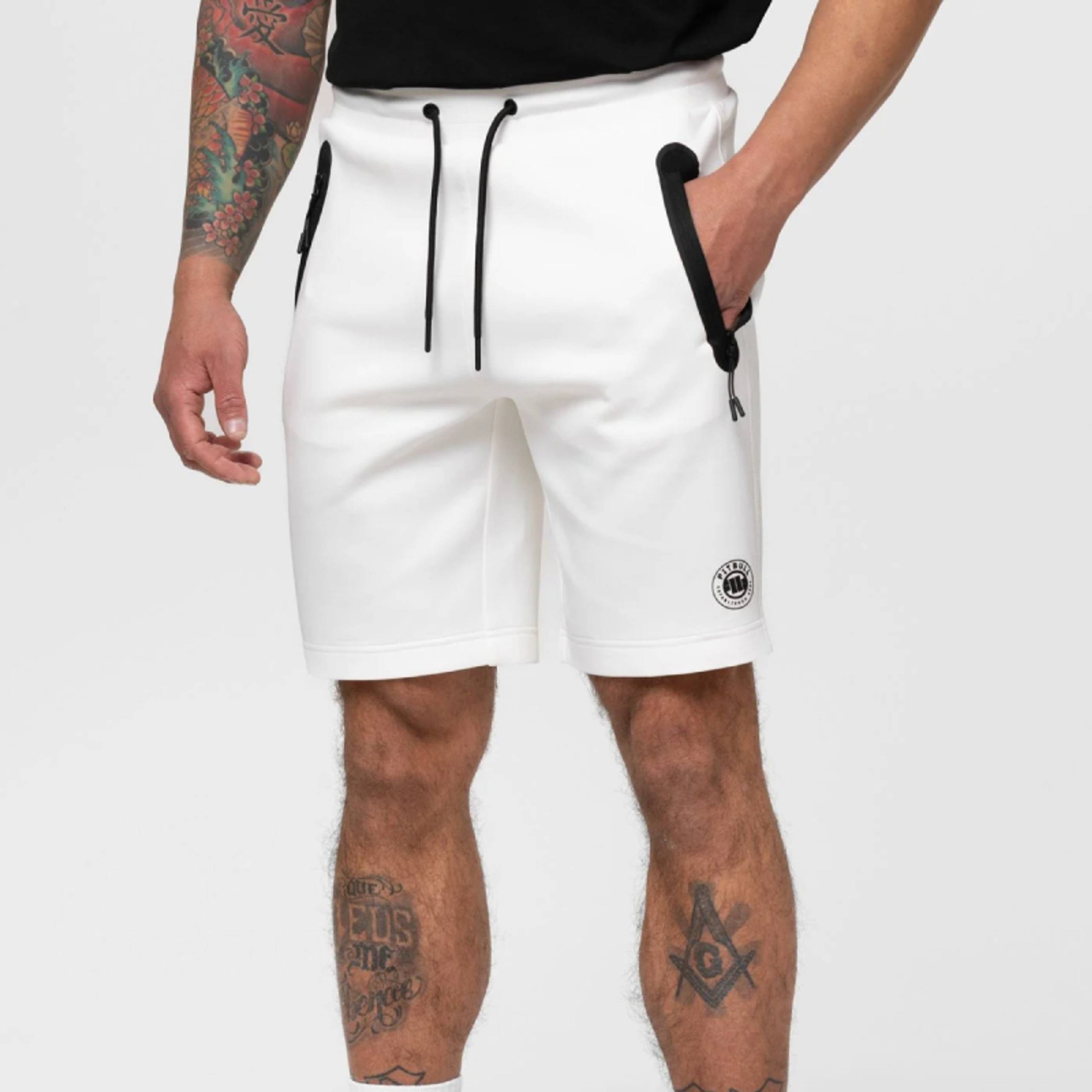 White athletic shorts with black pocket trim on a model
