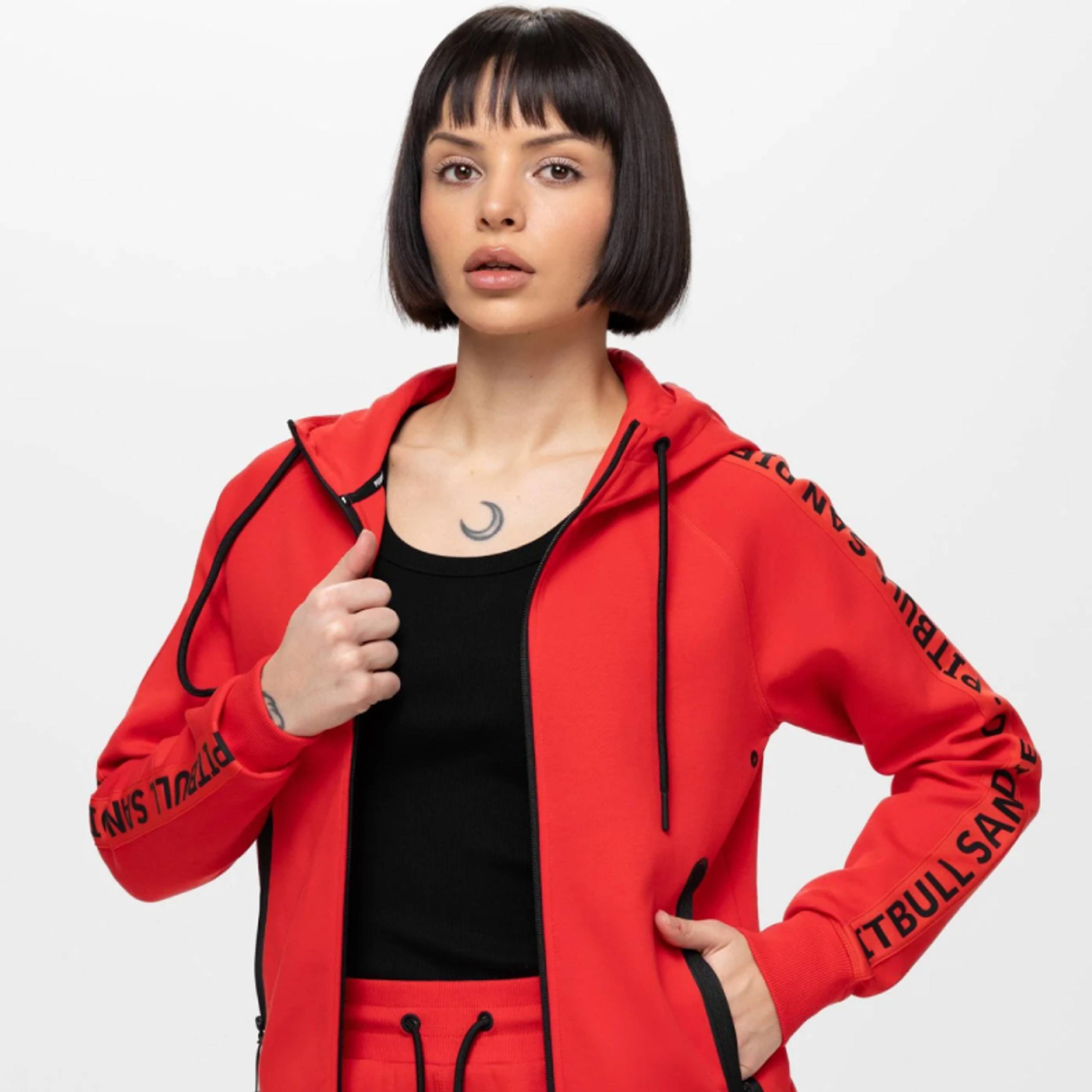 Woman in a red zip-up hoodie and matching pants