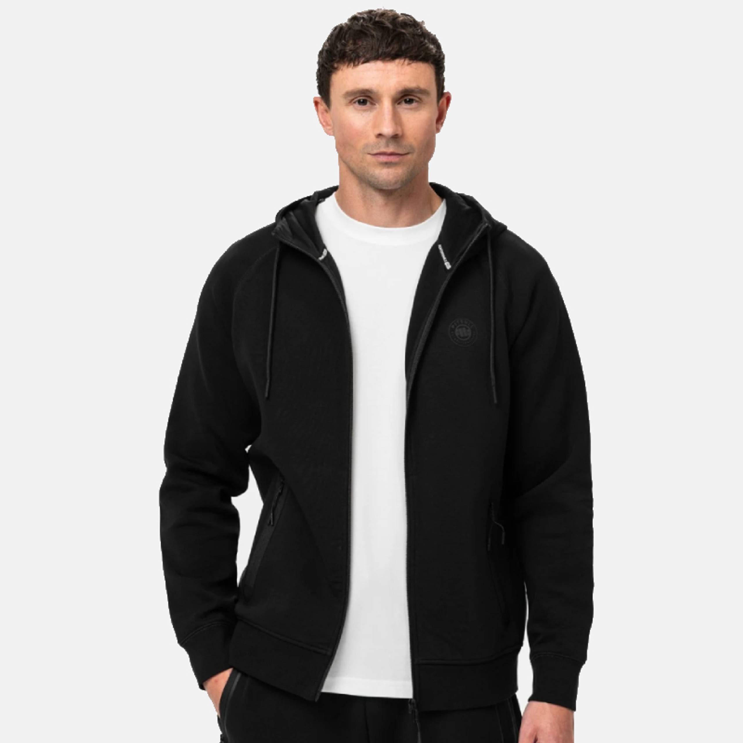 Man in a black zip-up hoodie over a white t-shirt