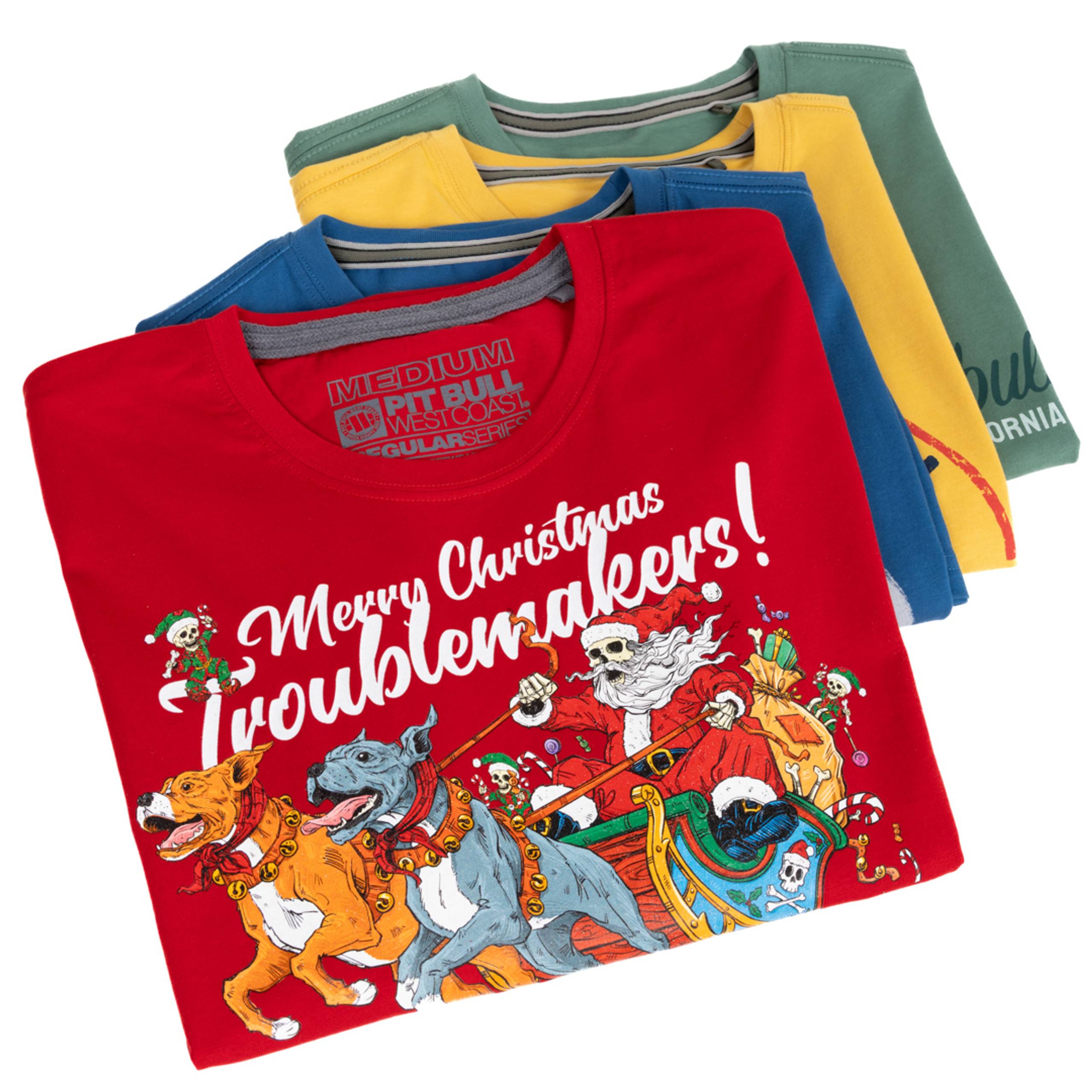 Stack of folded tees with a red Christmas graphic shirt on top