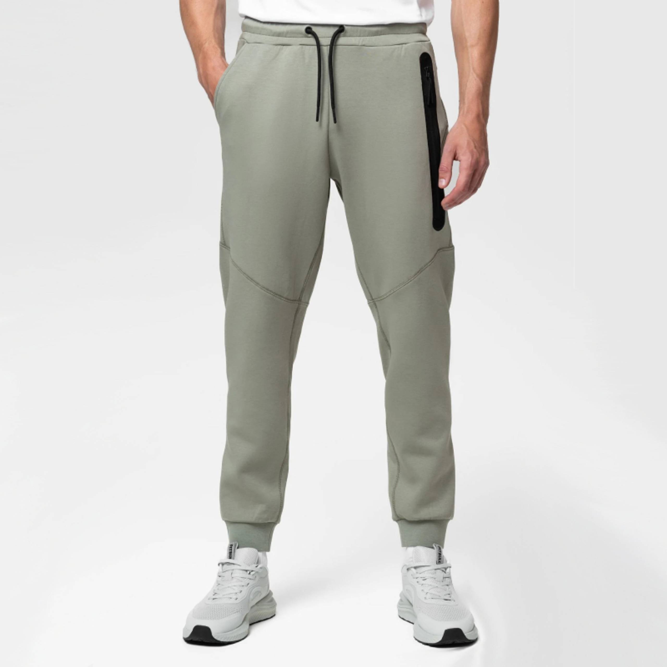 Olive green joggers with black zip pocket and ribbed cuffs