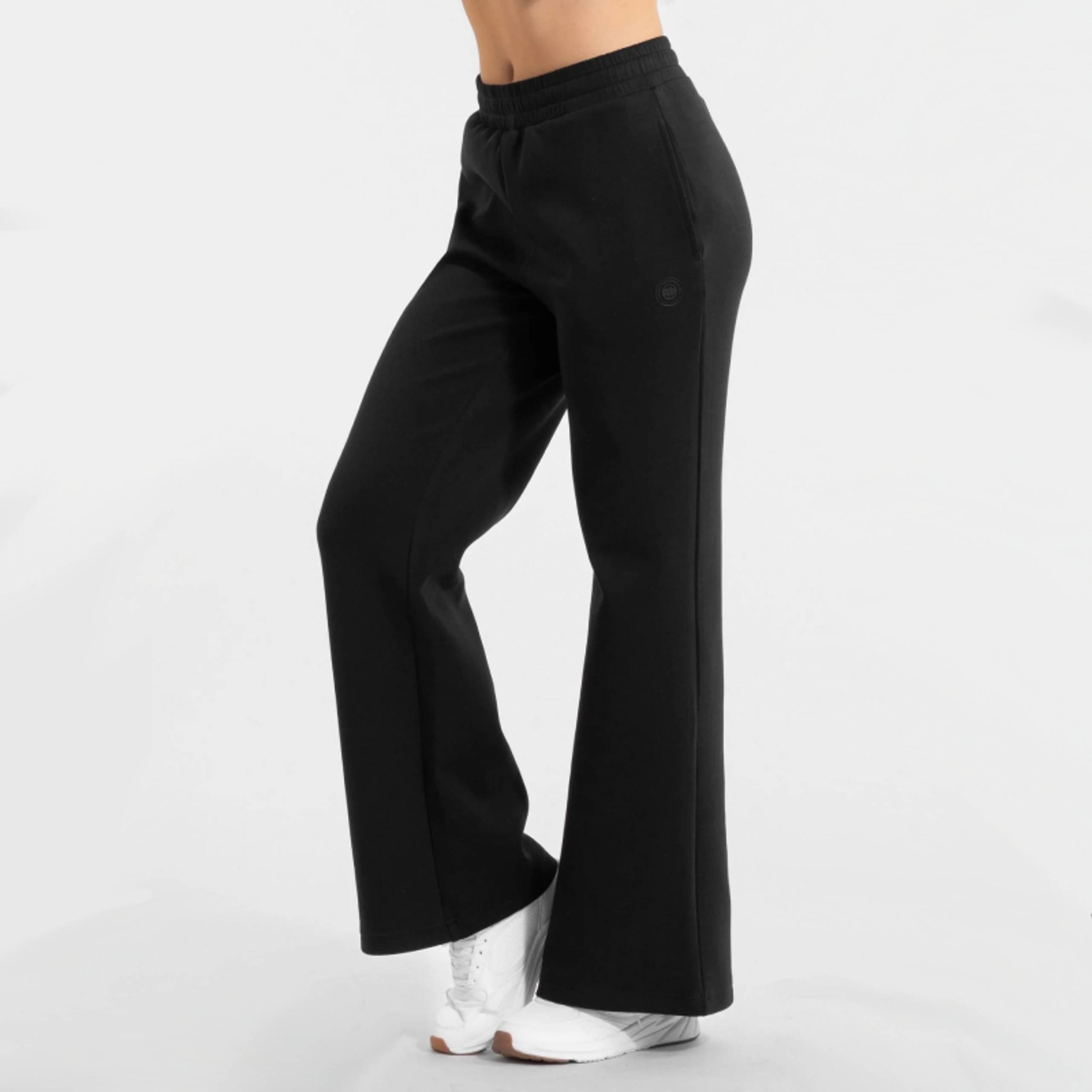 Black high-waisted wide-leg sweatpants with white sneakers