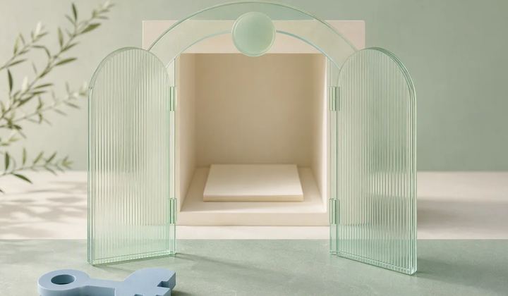 Translucent mint gates open onto a recessed ivory room, with part of a blue key in the foreground.
