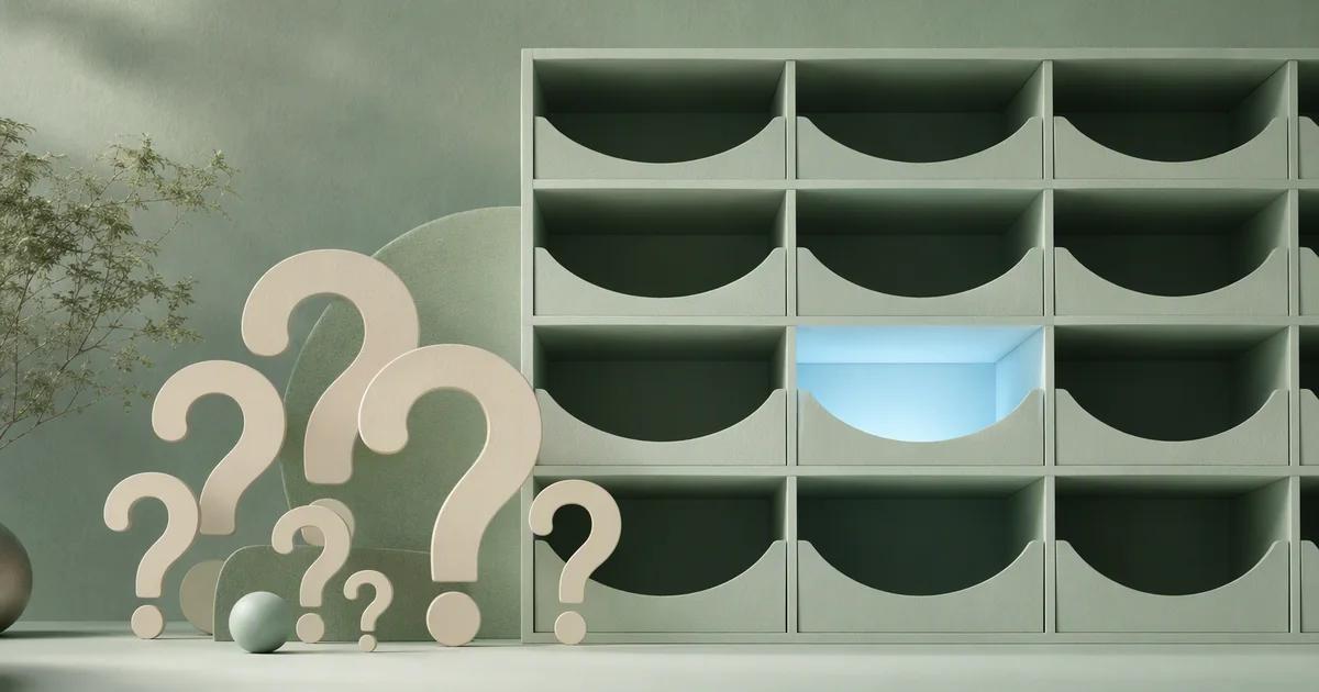 A set of ivory question-shaped abstract cutouts beside a mint filing grid with one empty compartment highlighted by pale blue light