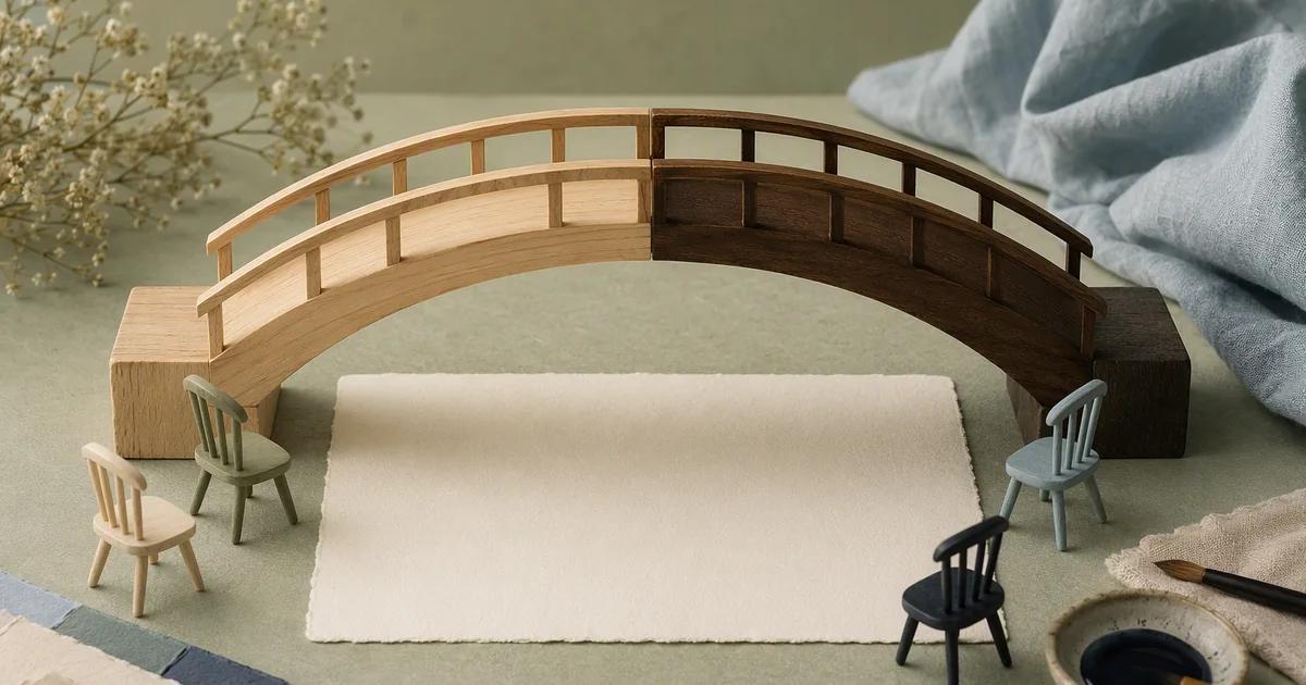 A two-tone wooden model bridge spans a blank card surrounded by miniature chairs.