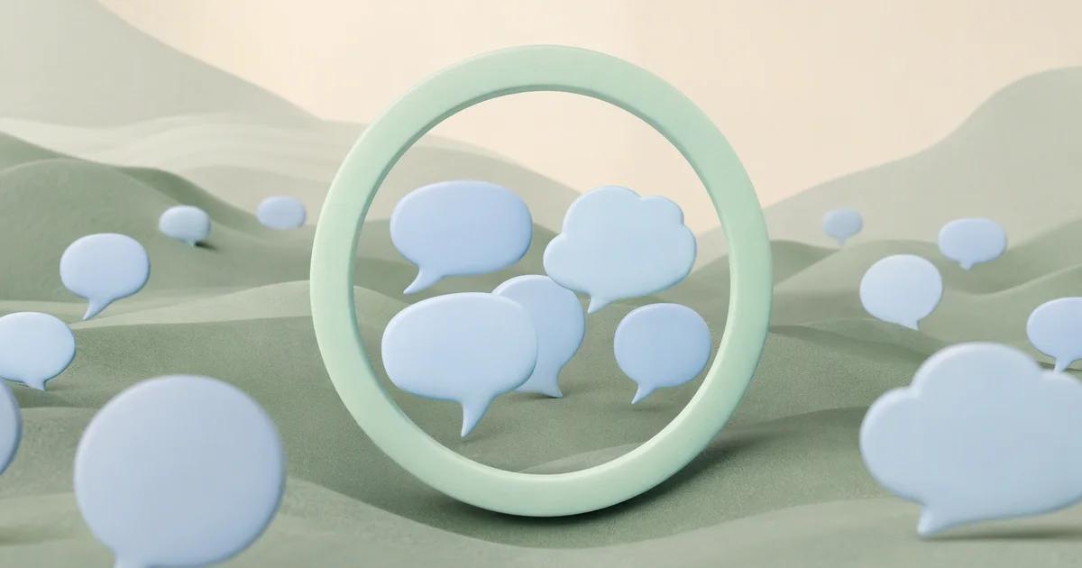 A small cluster of pale blue speech forms gathered through a mint circular frame, with many distant shapes remaining outside the frame