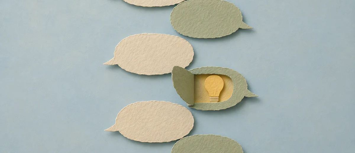 Cream and sage paper speech bubbles alternate on a pale blue surface, with one opening to reveal a yellow light bulb.