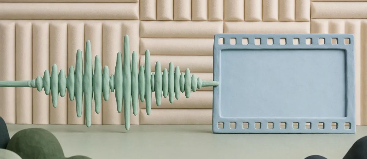 A mint audio waveform made from sculpted clay ends at a pale blue blank film frame with ivory soundproof fabric behind it.