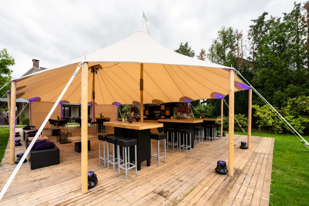 A Folly & Fern marquee in a countryside setting