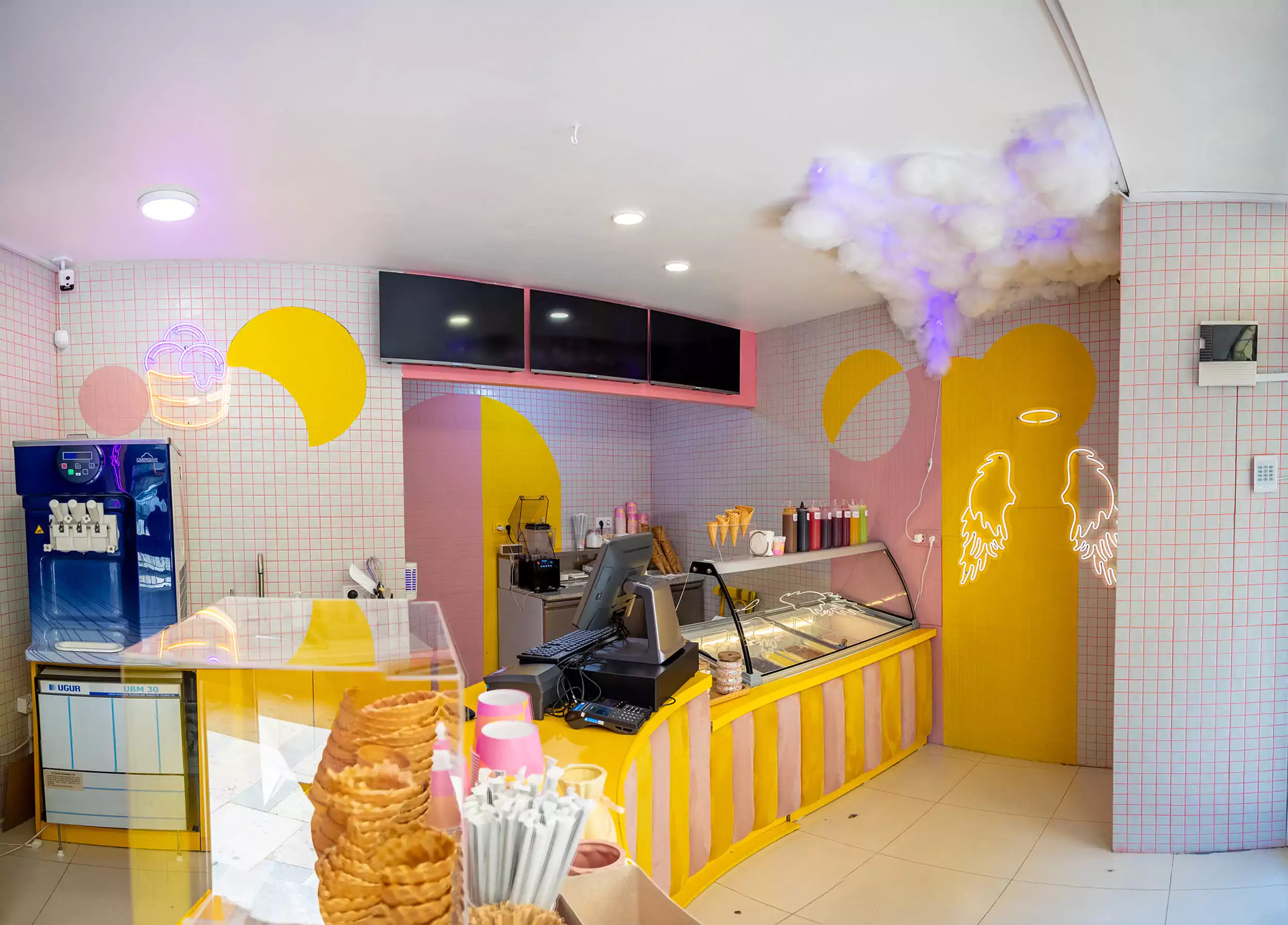 Barambo ice cream shop interior at 11 Melikishvili - yellow-and-pink palette and decorative ceiling clouds