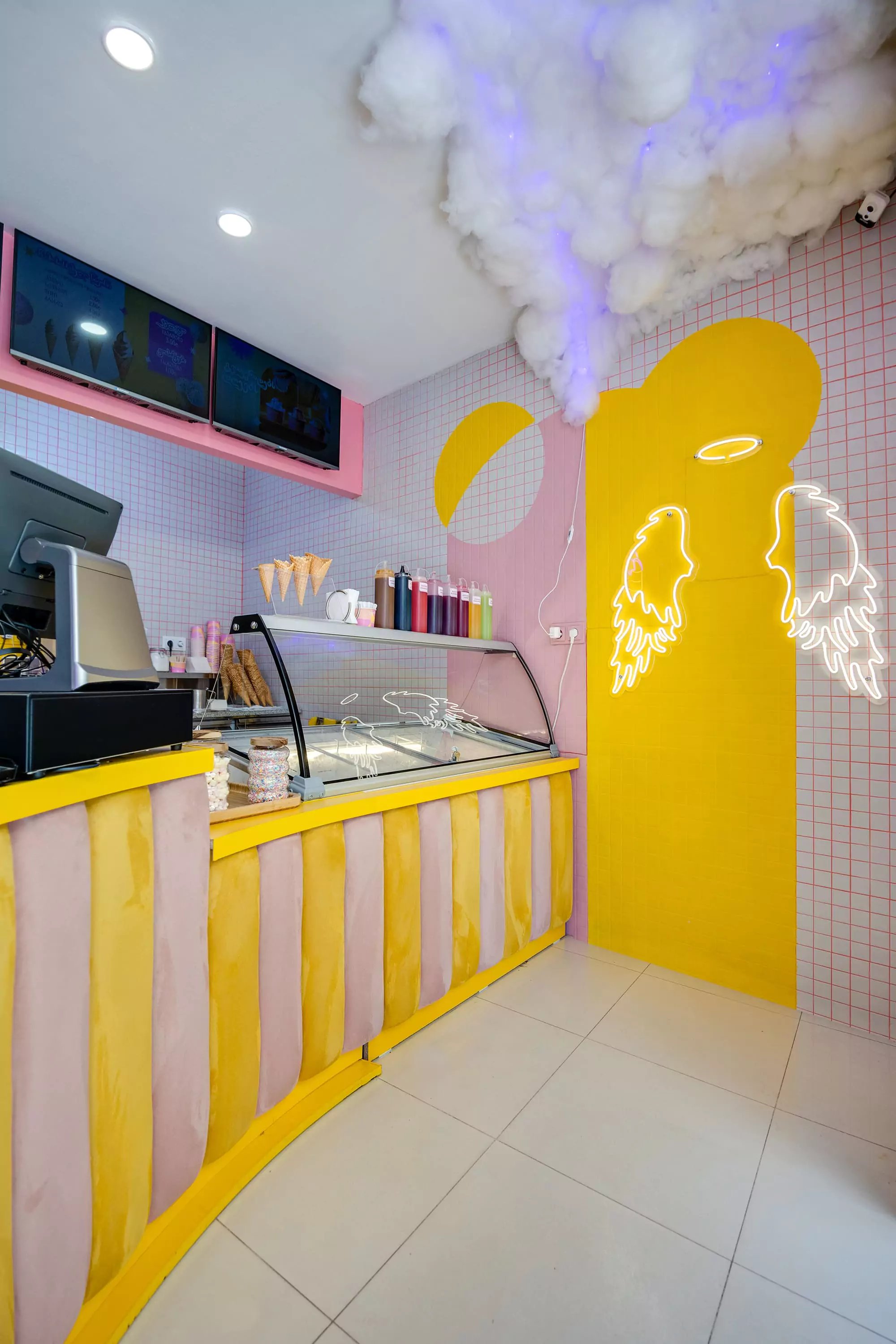 Barambo ice cream counter with neon angel wings and grid tiling
