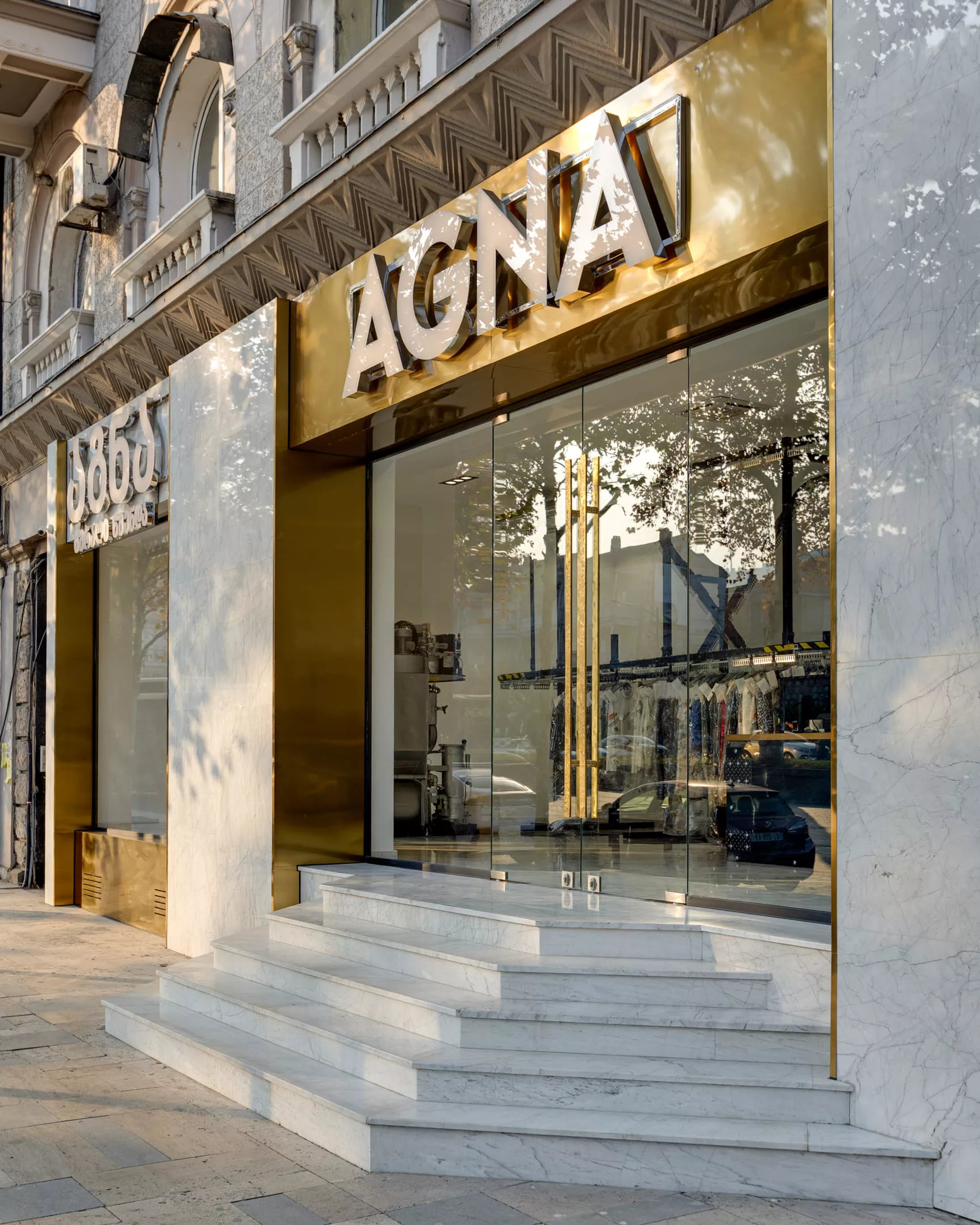 AGNA retail storefront - glass display window, brass accents and marble steps