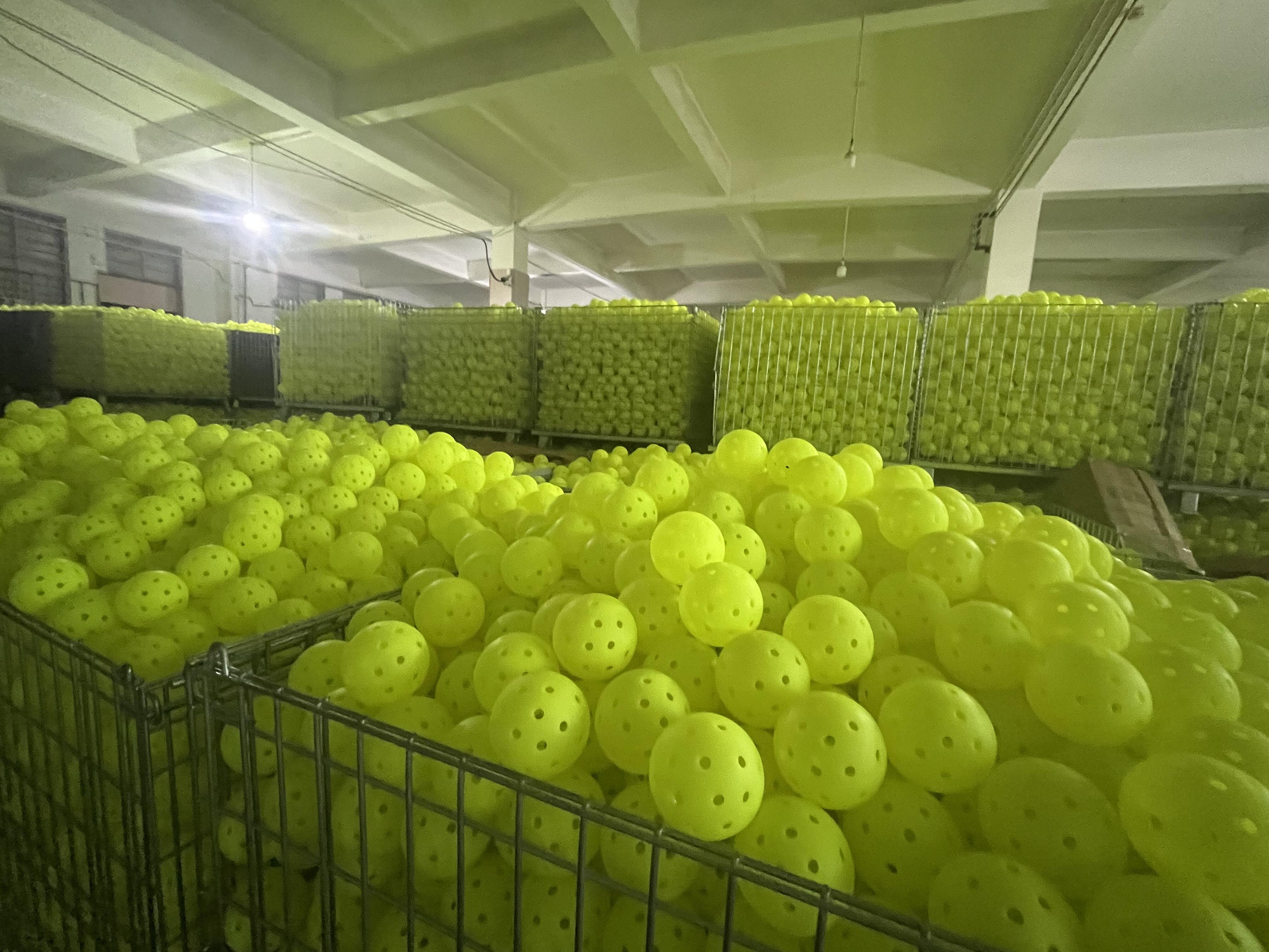 Rotomolded 40-hole outdoor pickleballs on a source factory production line