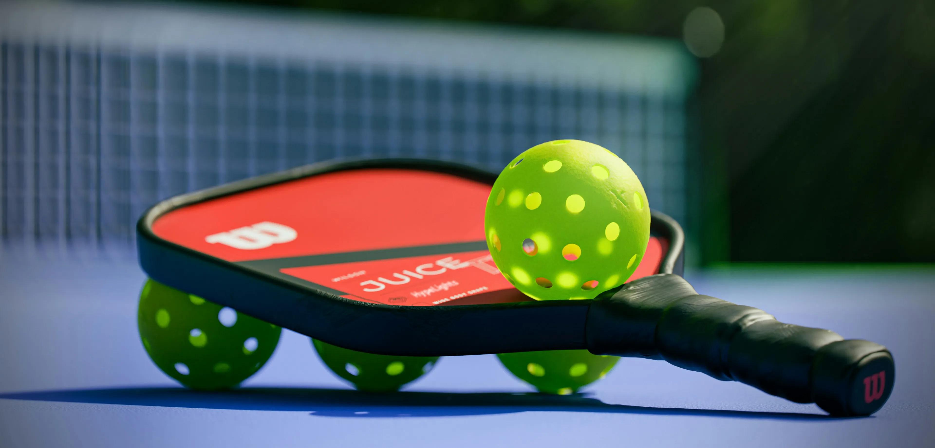 Durable rental pickleball paddle with reinforced edge guard specified for facility fleet use