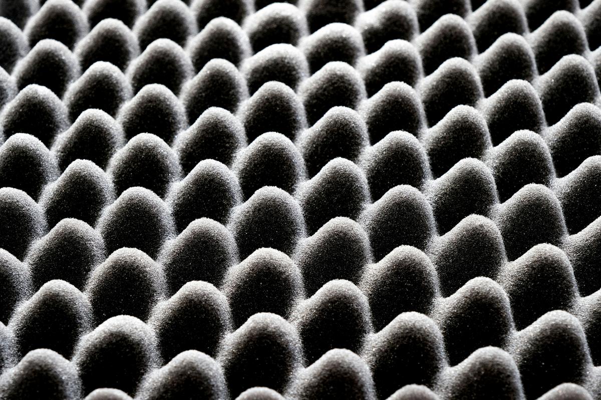 Close-up of open-cell foam showing its compressible cell structure, the property Rule 3.D.4 tests for rather than the material name it carries