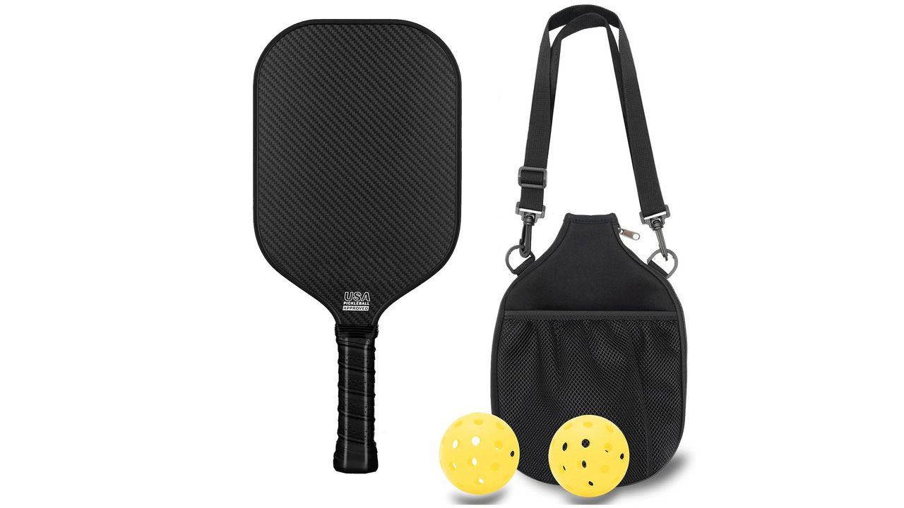 Raw carbon fibre pickleball paddle face shown without printed graphics alongside a carry bag and two yellow outdoor balls