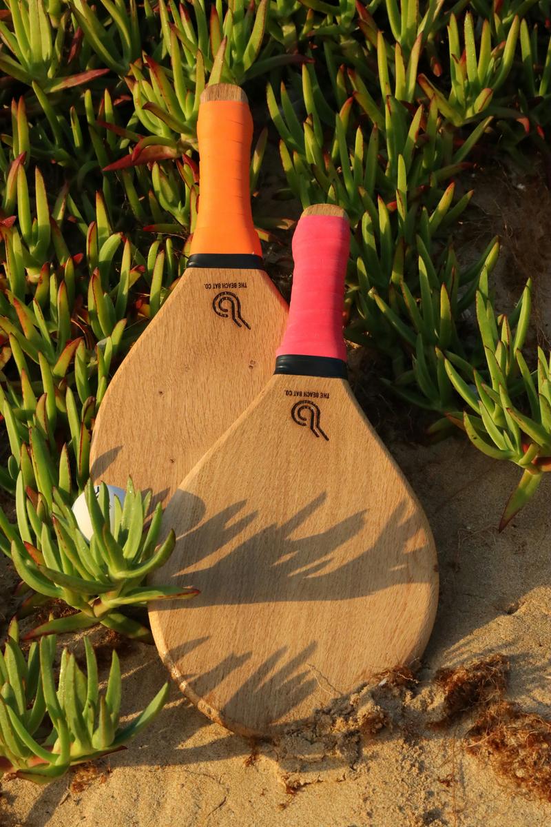 Hyper-realistic commercial photography, stacks of identical blank pickleball paddles neatly arranged in rows inside a large modern warehouse facility, cool ambient overhead lighting creating subtle shadows, wide angle perspective showing scale and volume, clean B2B aesthetic, no text, no brand logo