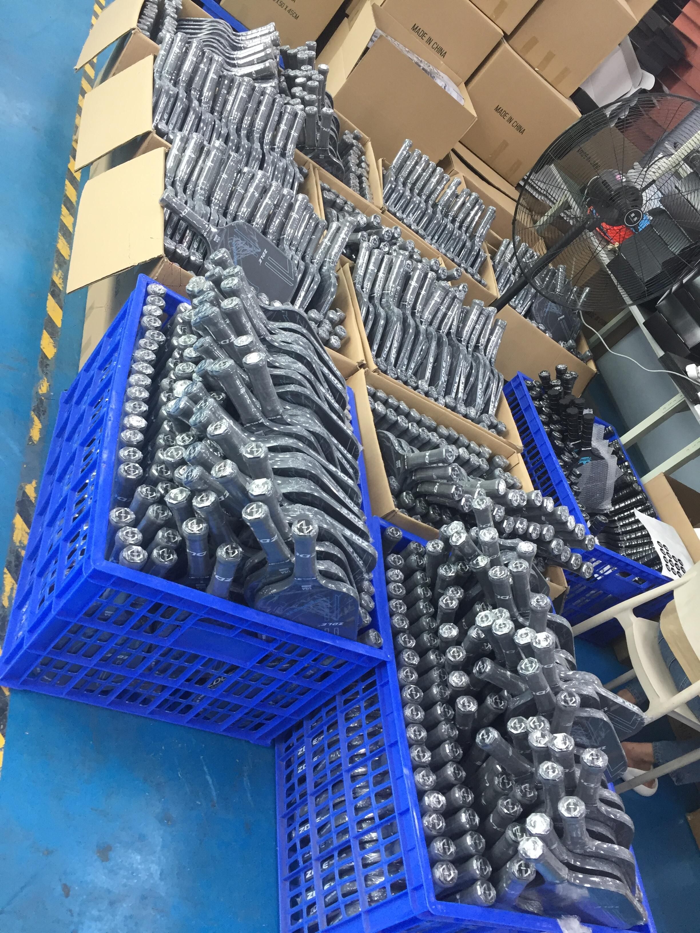Carbon fiber pickleball paddles in factory stock, ready for material and construction inspection