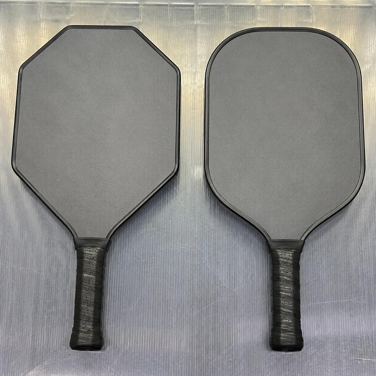 Hyper-realistic photography, side-by-side comparison of two pickleball paddles: left paddle with unique custom geometric shape and separate steel mold, right paddle with standard rounded stock shape, both on a polycarbonate surface, diffused top lighting, no text, no brand logo