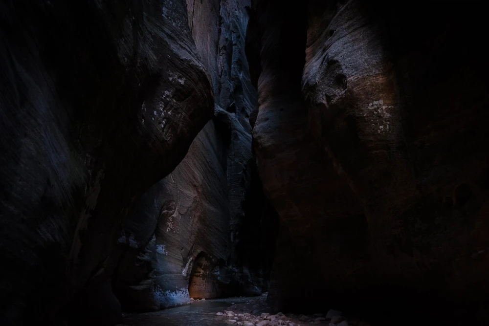 The canyon walls closing in and darkening as the route narrows