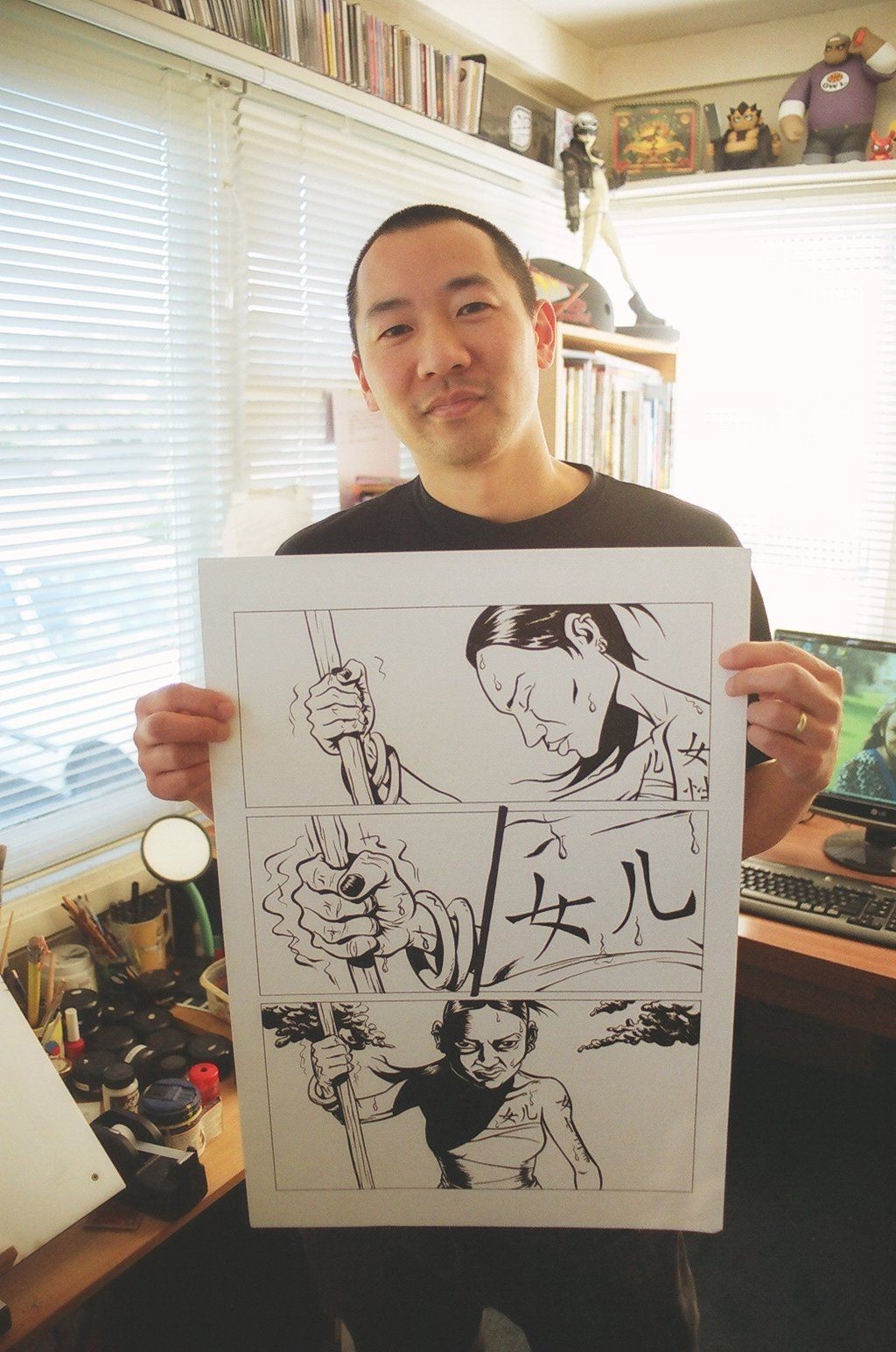A man holding a page from a graphic novel.
