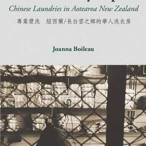 A light green cover with a black and white photo of a man working in a laundry
