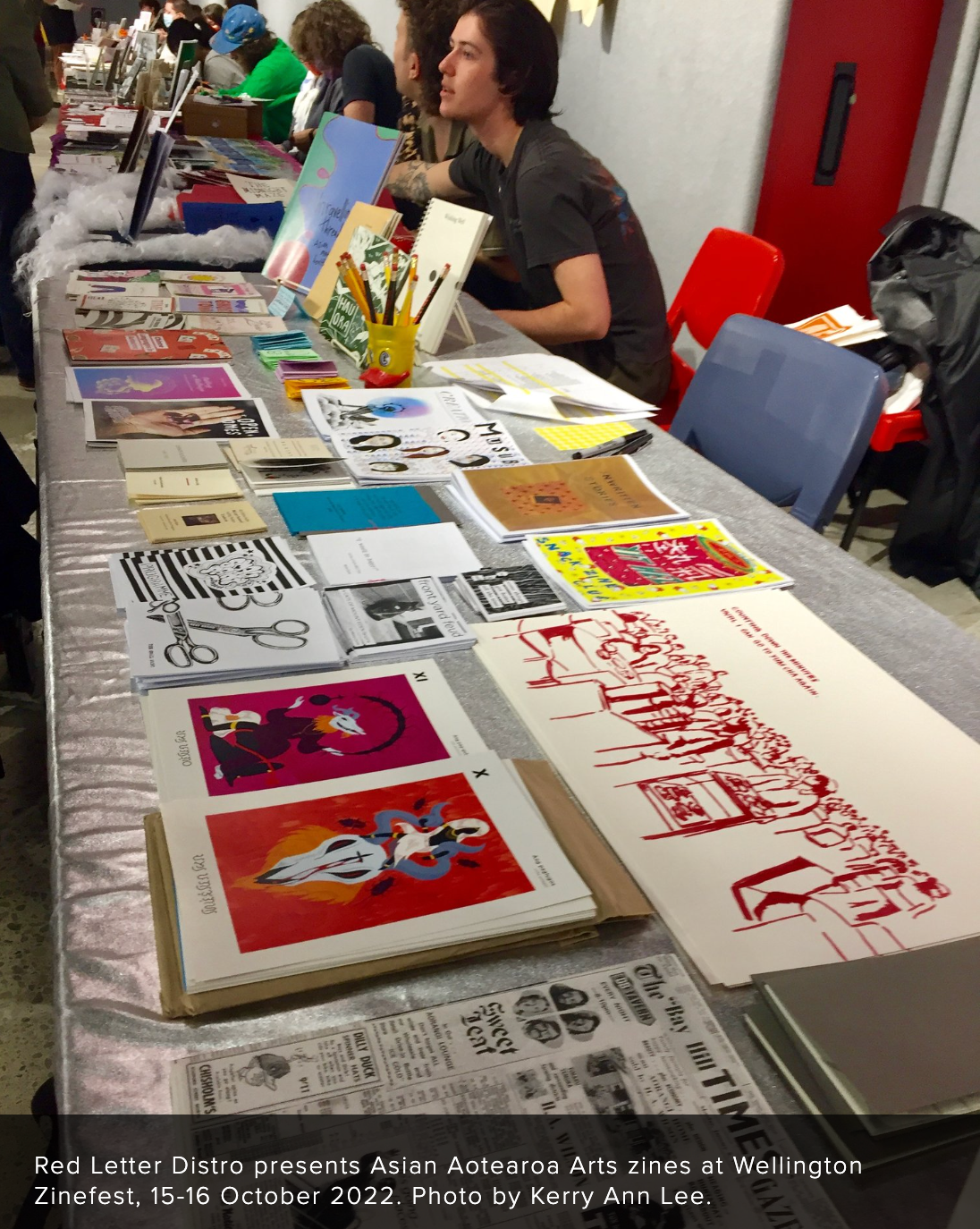 A table spread of various zines and posters.