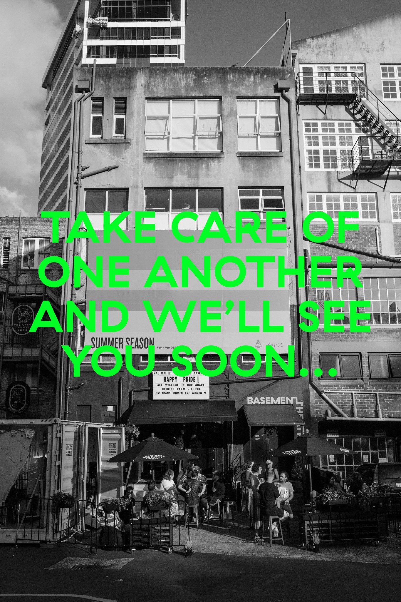 Lime green text over a black and white photo of a busy theatre reads: "Take Care of One Another and We'll See You Soon".