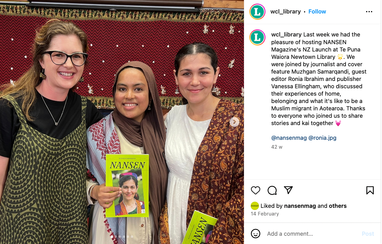 Three people smiling and holding a magazine that has a green cover and an image of a woman on the front.