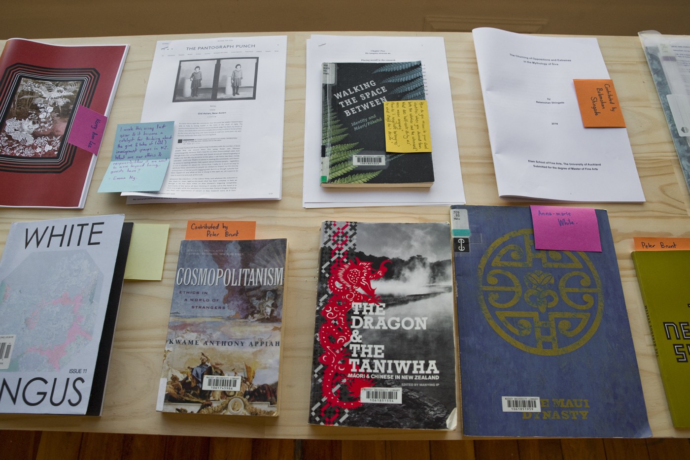 A selection of books and exhibition catalogues on a table.