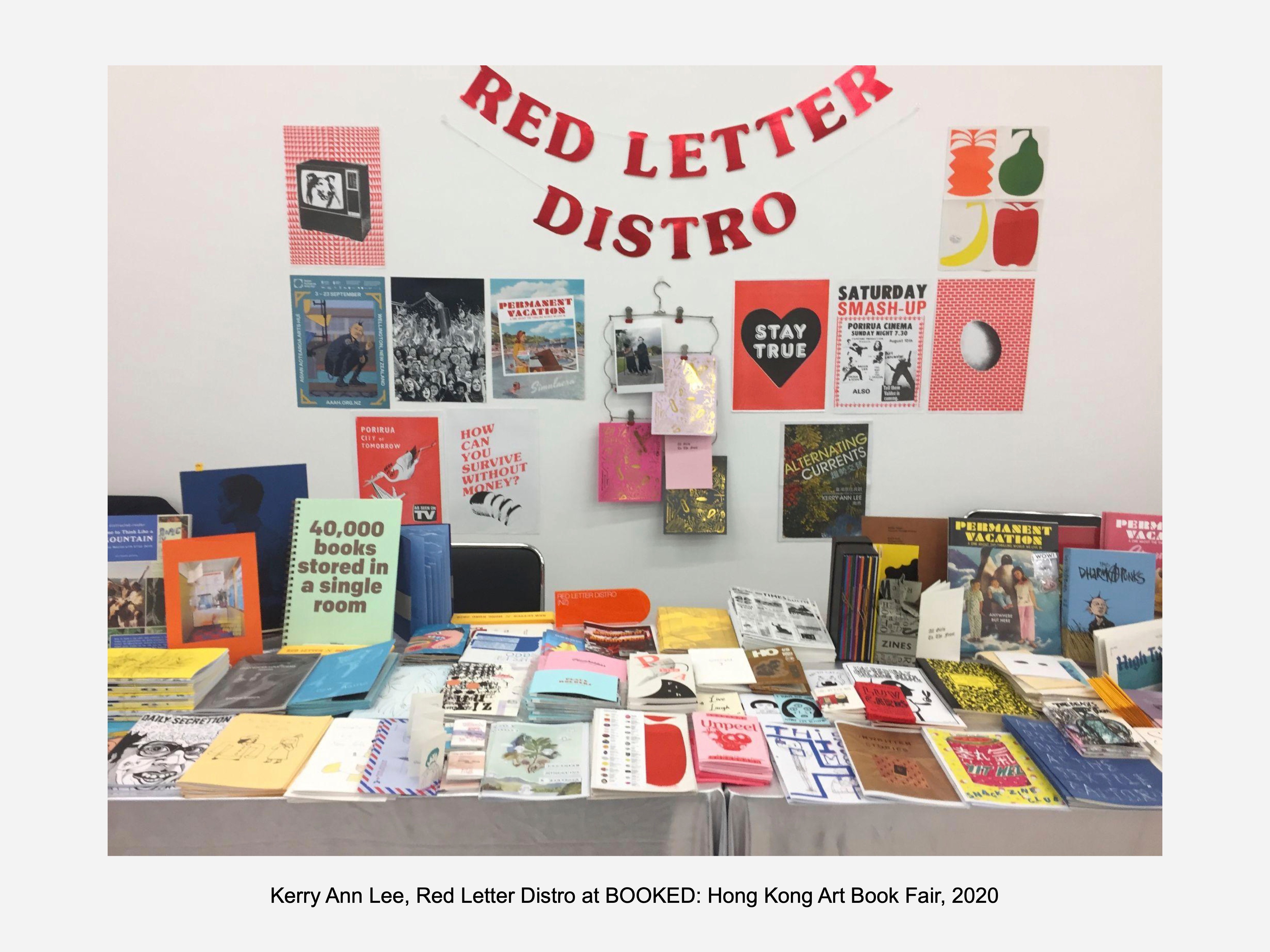 A table of zines with a banner reading 'RED LETTER DISTRO'