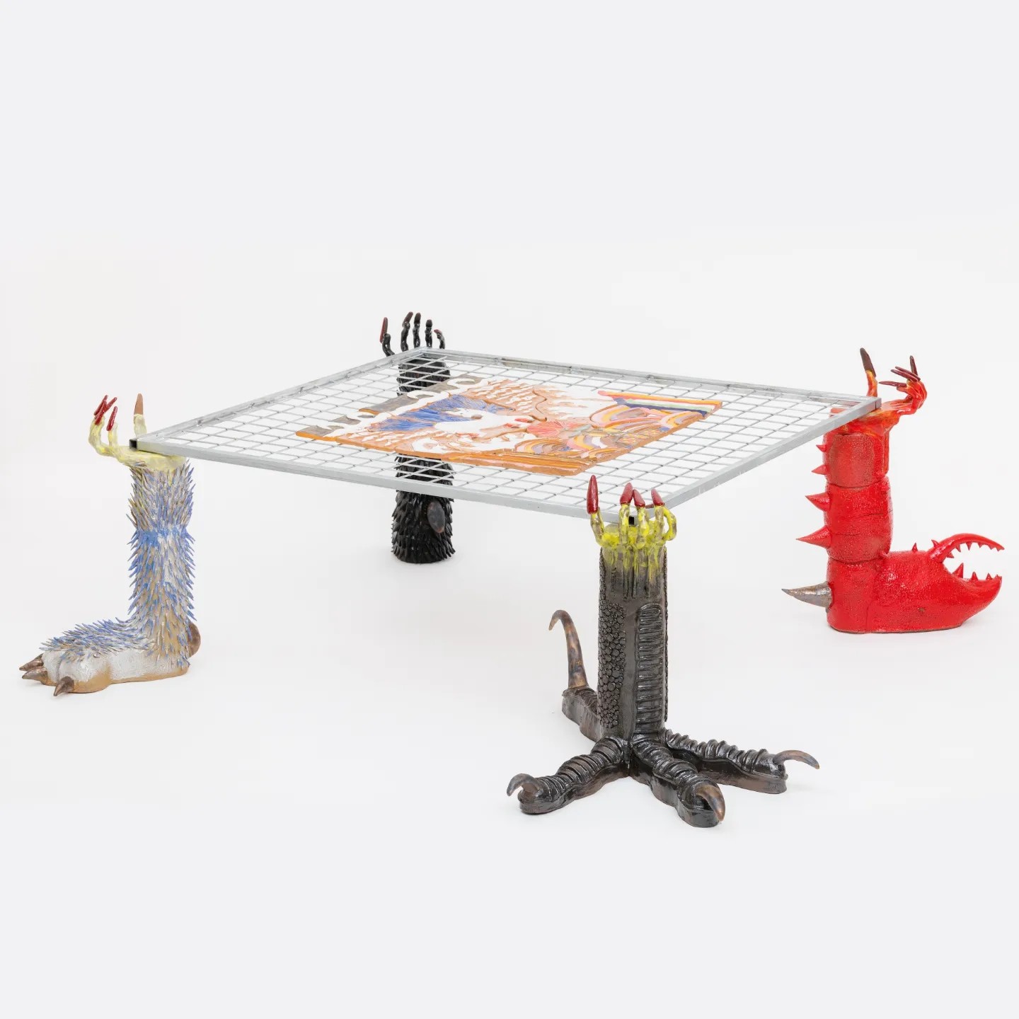 Photo of a table with four different creatures legs as the base