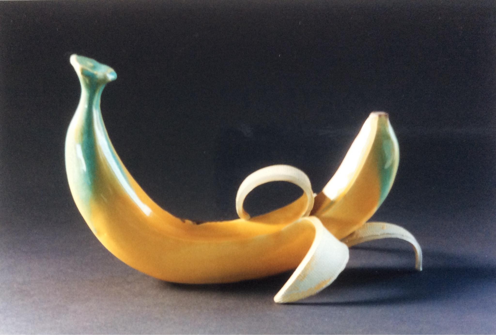 Ceramic partially peeled banana with another unpeeled banana inside