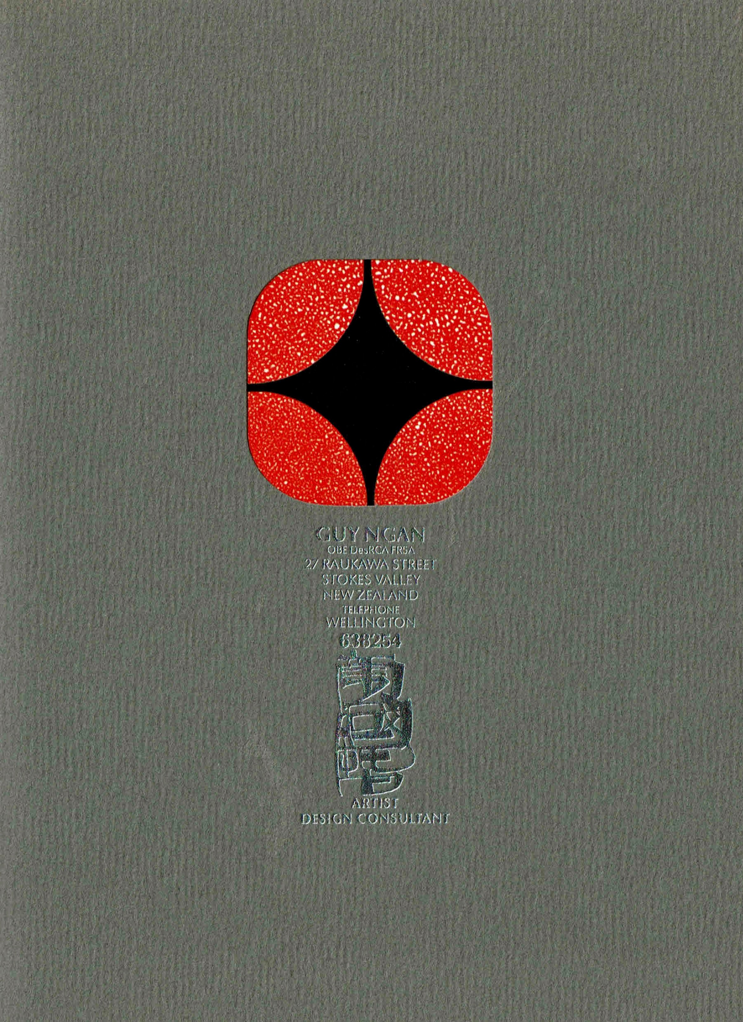 Grey card cover with a cutout in the centre showing a red and black diamond design, above Guy Ngan's name