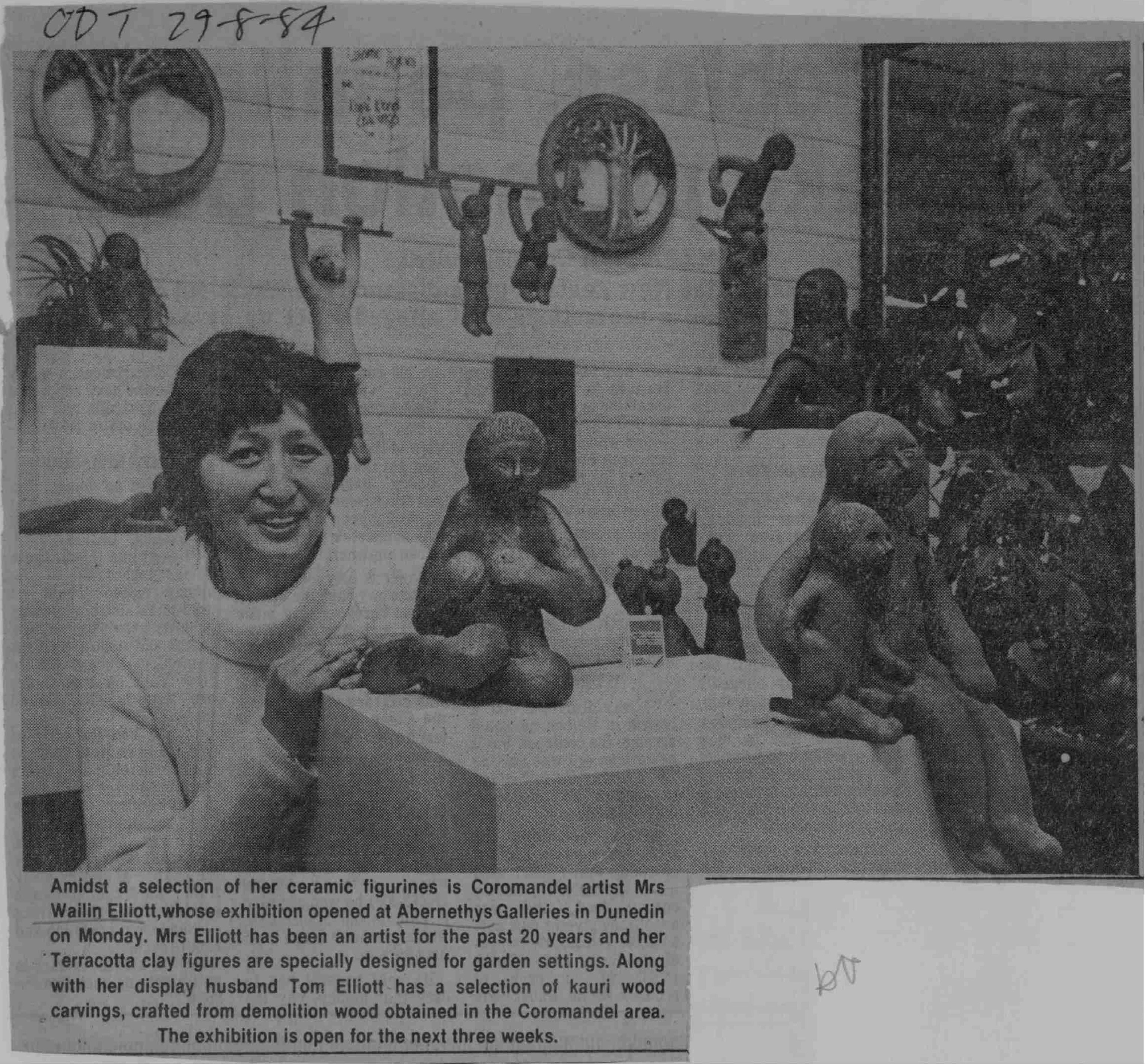 Newspaper clipping with a photograph of Wailin Elliott with some of her clay sculptures.