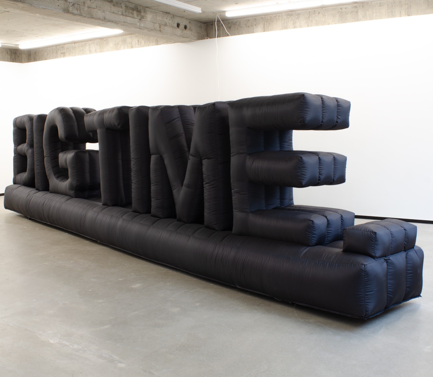 Photo of a black inflatable object that is formed to spell the phrase 'BIG TIME.' 