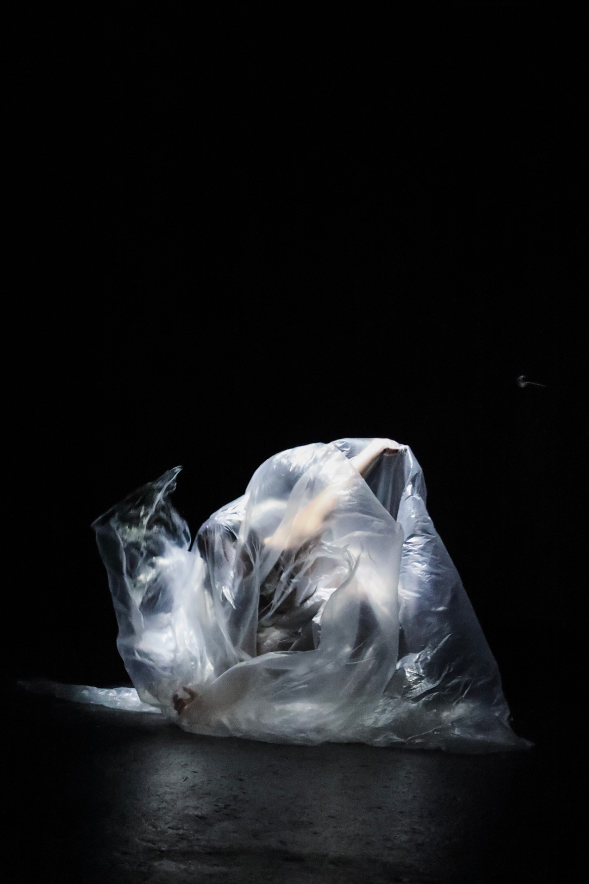 Person dancing inside a transparent plastic bag