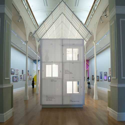A small to-scale house made of paper sits inside Auckland Art Gallery