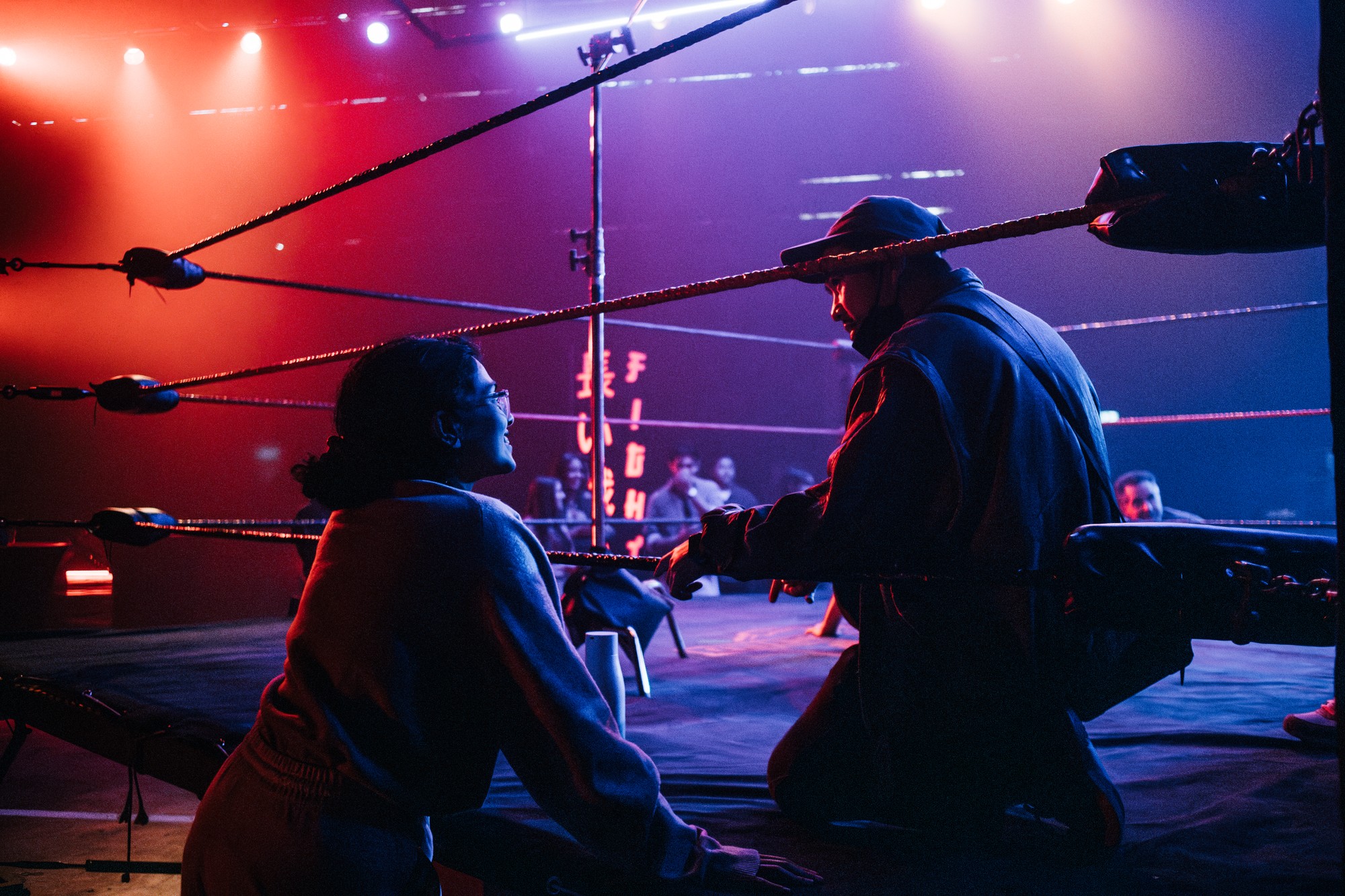 Ankita looking into a boxing ring on a film set.