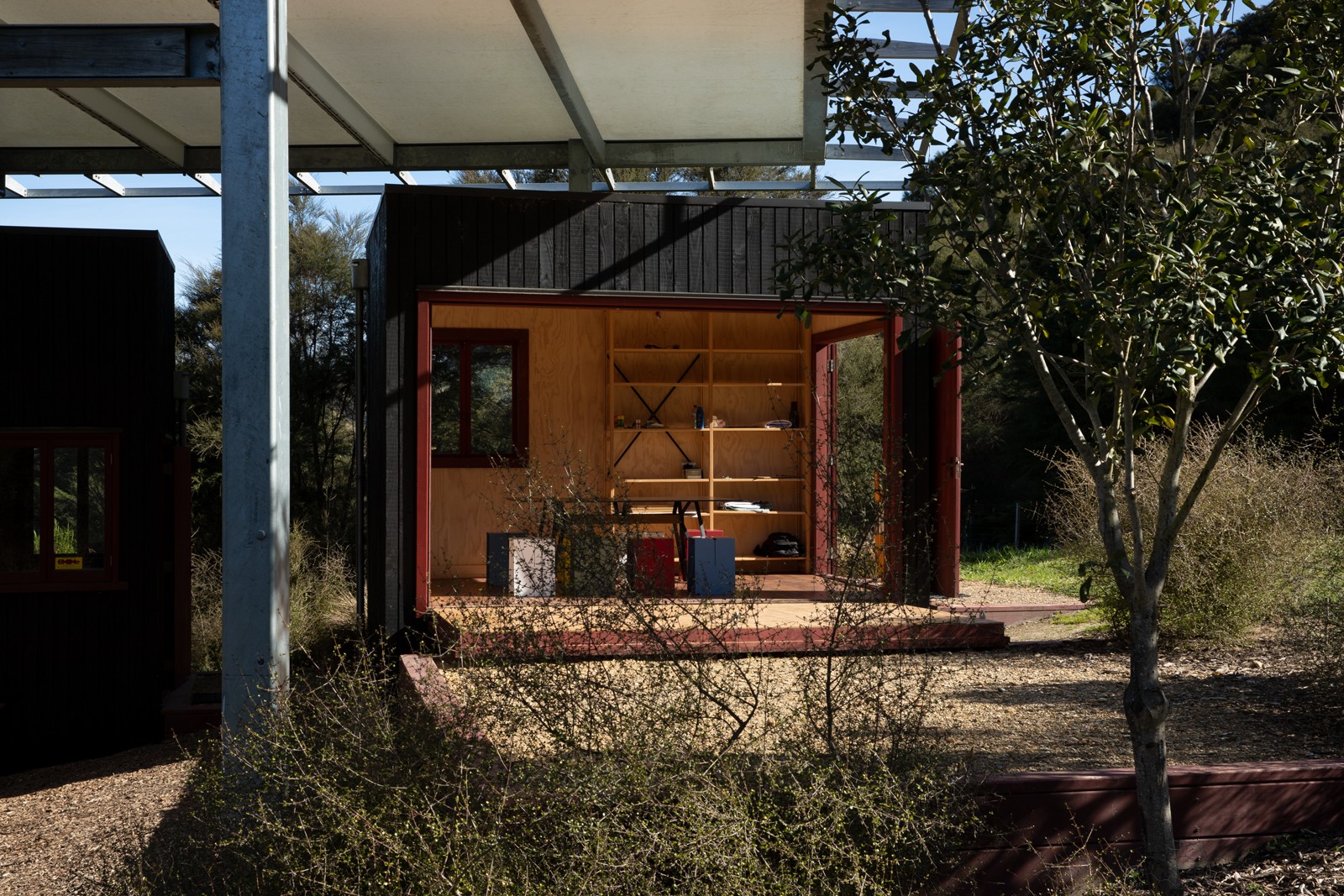 View from under a canopy looking at an open-sided classroom shelter.