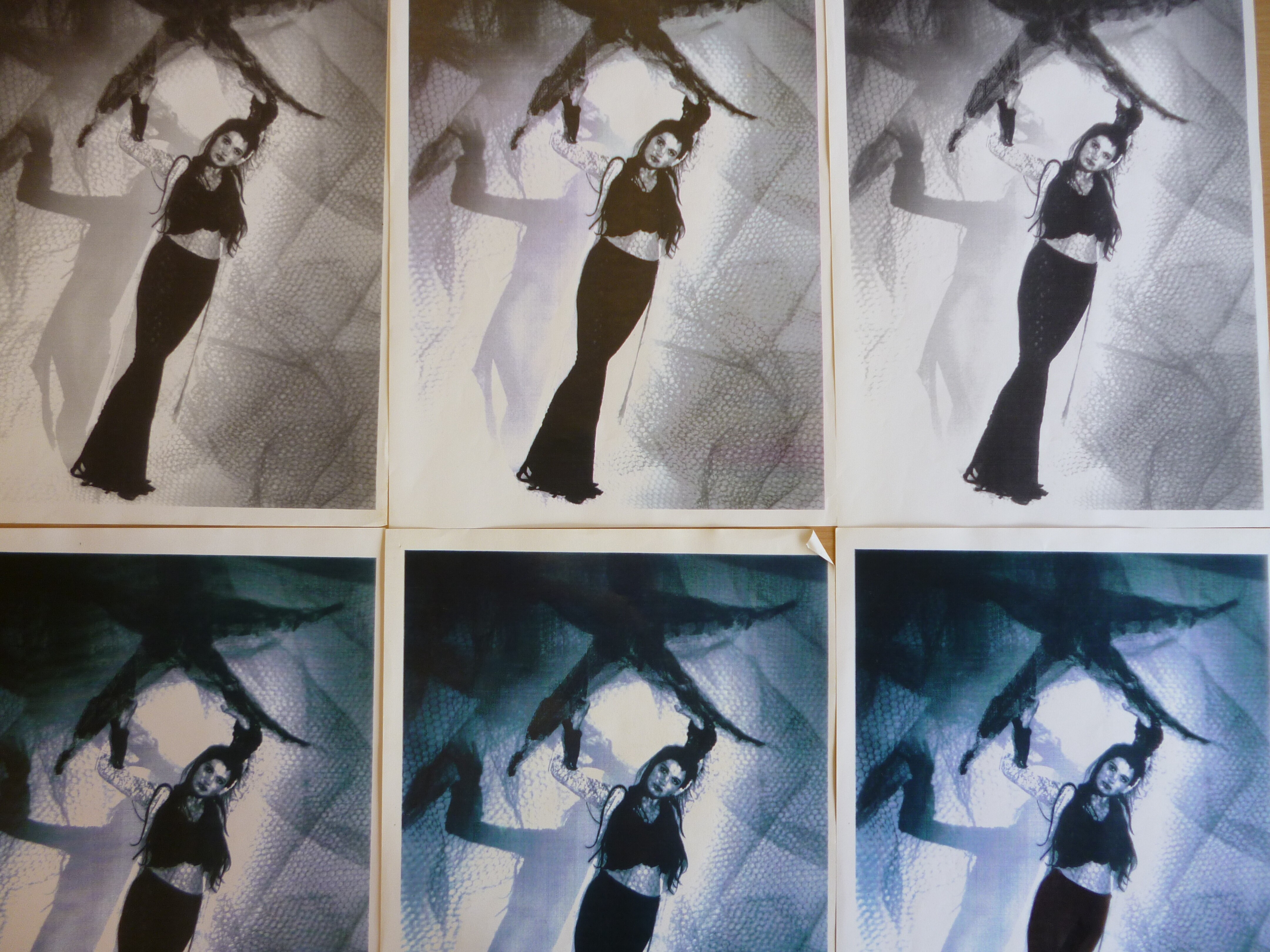 A grid of six prints of a photo of a woman with long dark hair and a long black skirt and top holding a starfish over her head.