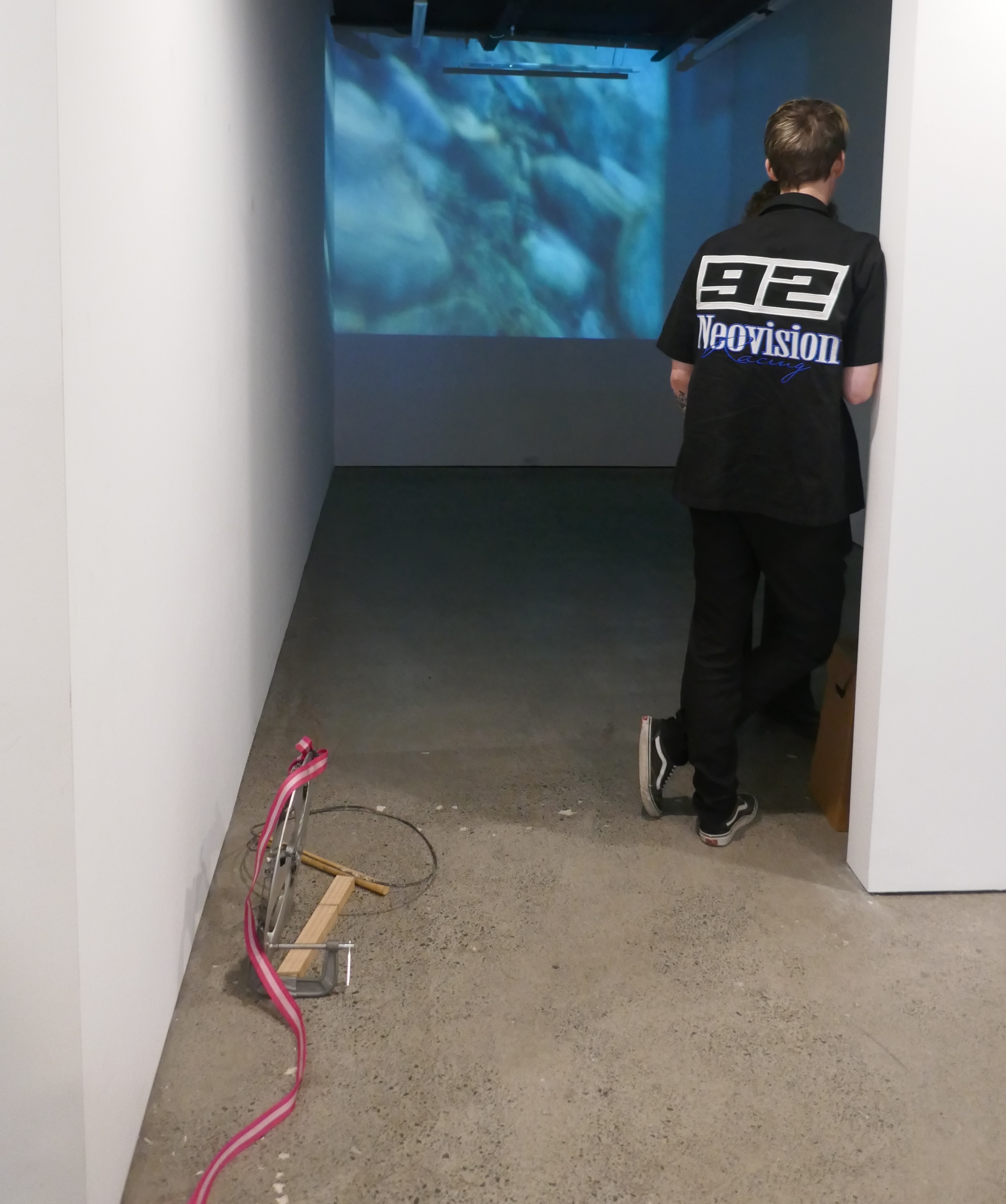 Photo of a person looking at a projection of a video