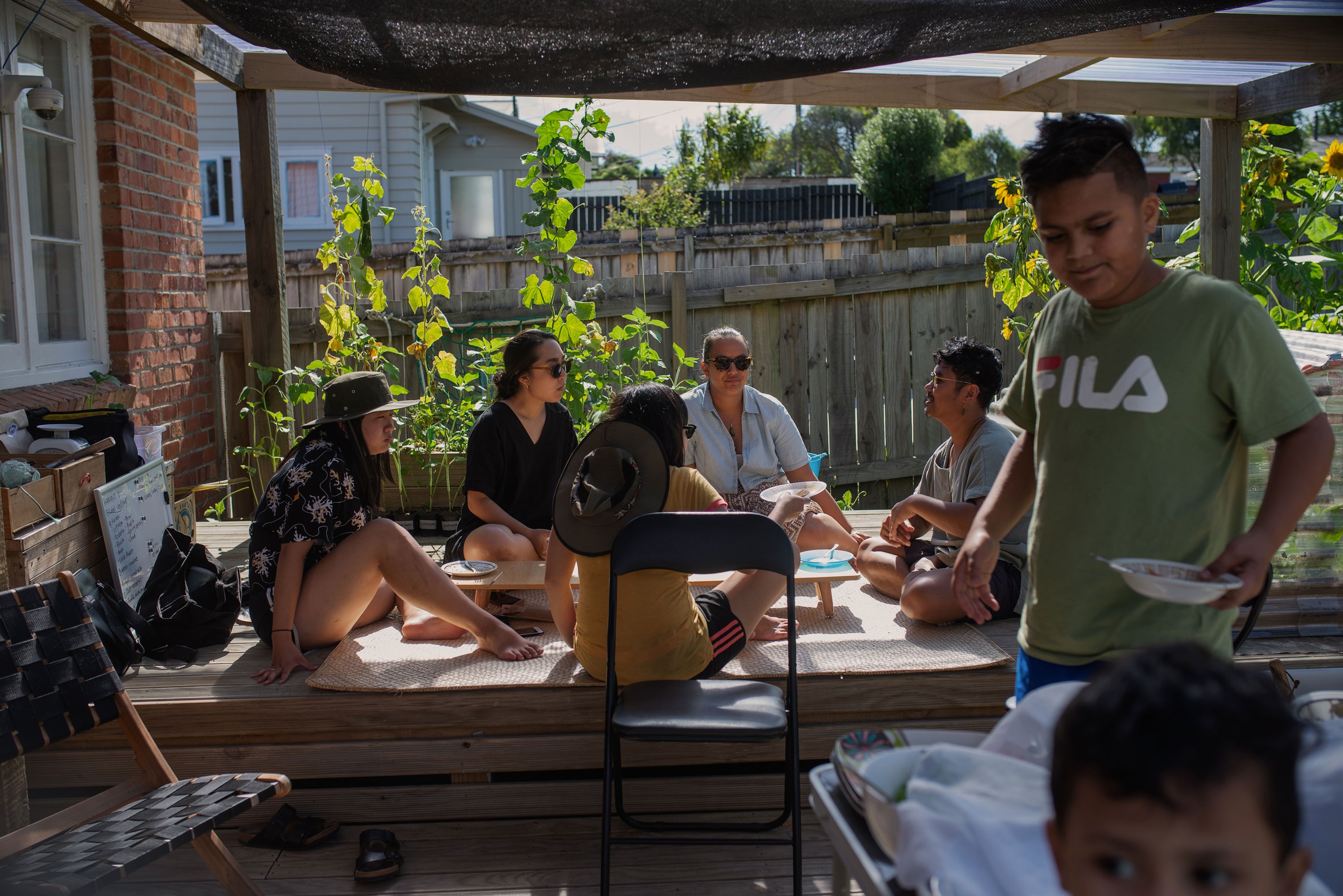 Five people sitting around a low table sharing stories