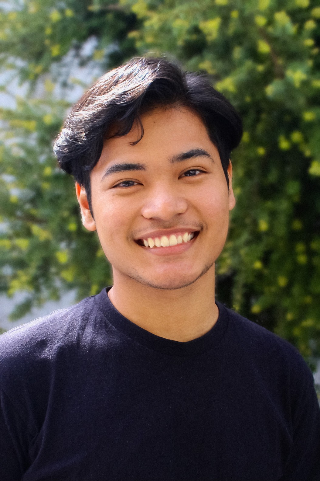 Smiling Filipino-looking person wearing black shirt