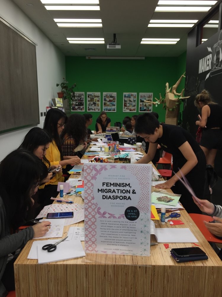 A table of people concentrating on making zines.