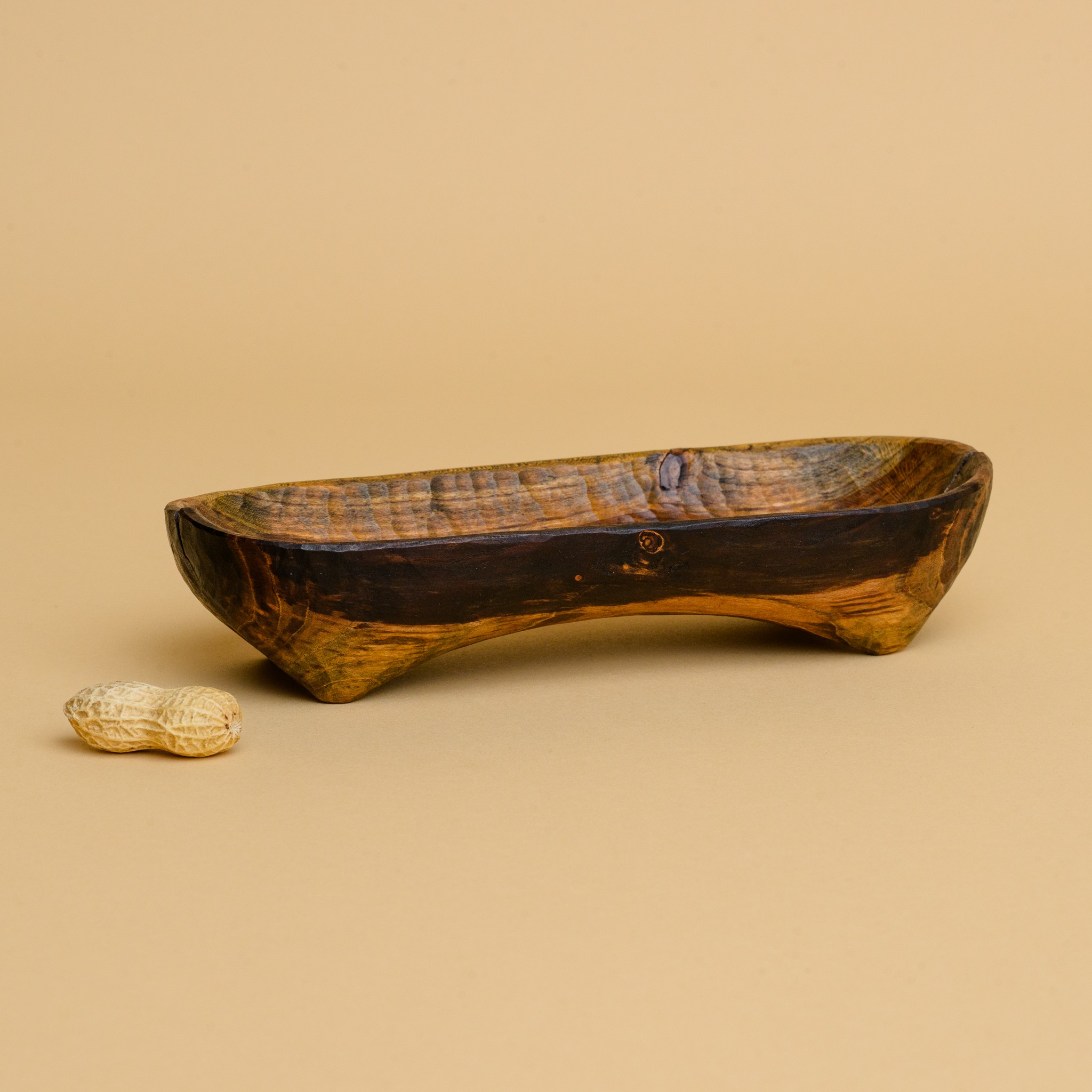 A long skinny hand-carved wooden tray