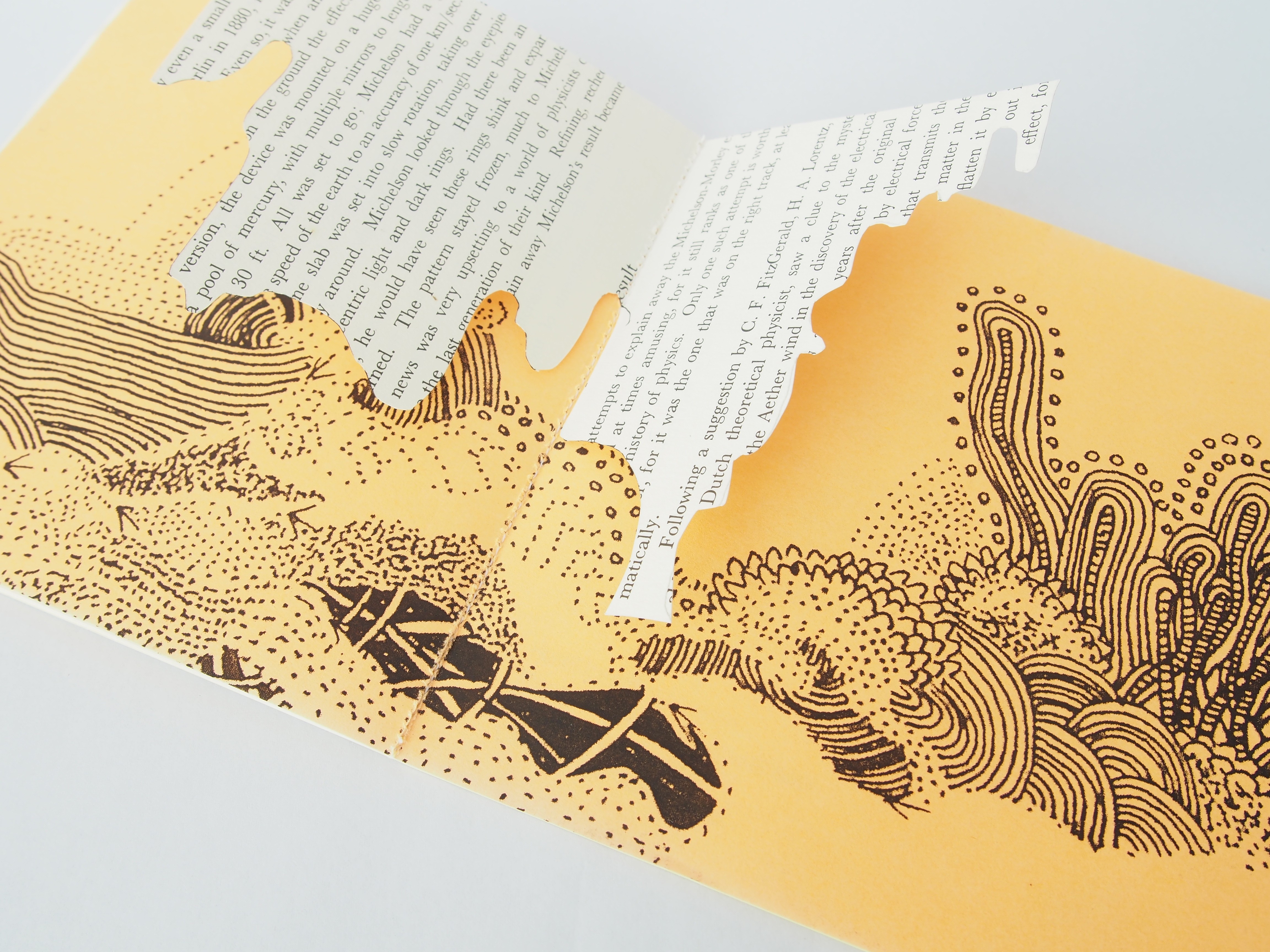 Open spread of an illustrated zine with words that pop-up in the middle.