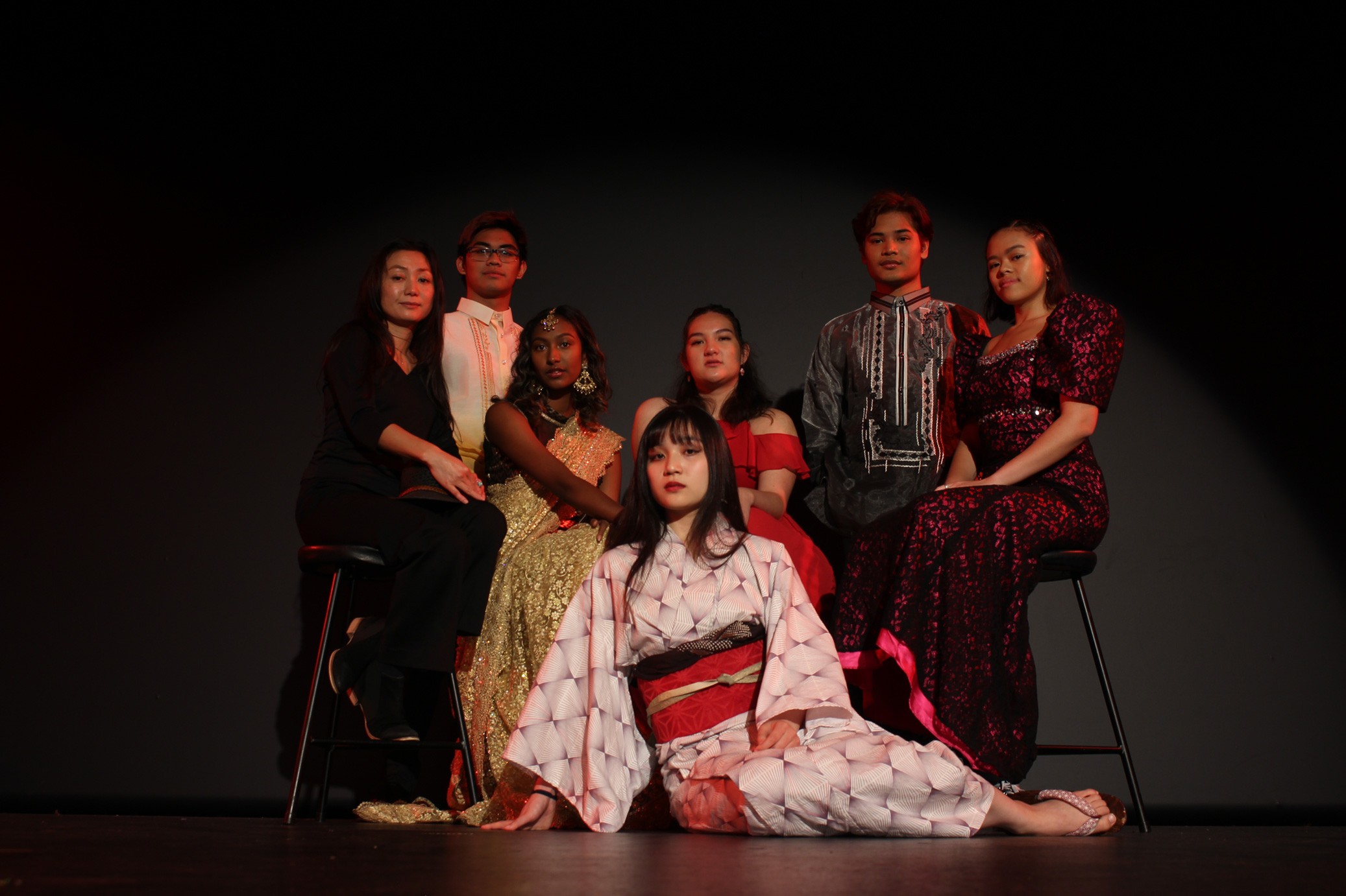 Various Asian folks posing while wearing their traditional garb